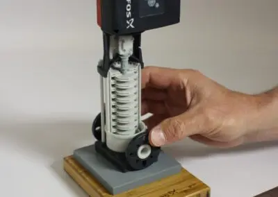 scale model of large industrial pump with ruler and hand for demonstrating size